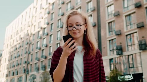 Woman Using Smartphone in Urban Setting