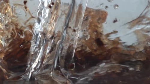 Pouring water into brown powder and mixing liquid