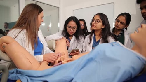 Medical Professionals Training with Birthing Mannequin in Hospital