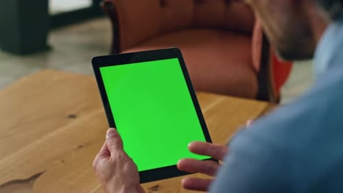 Man Holding Tablet with Chroma Key in Living Room