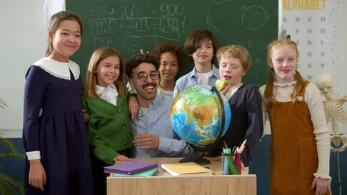 Elementary School Class Children Communicate with the Teacher Answering Question