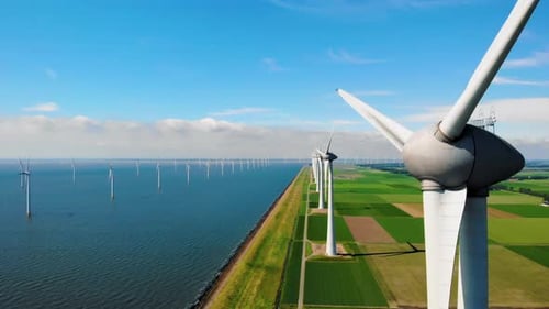 Windmill Turbines at Sea Seen From a Drone Aerial View From Above at a Huge Winmill Park
