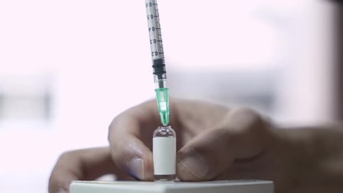 Withdrawing Medicine from Vial with Syringe Close-up