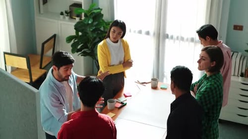 Diverse Team Brainstorming Ideas in Modern Office