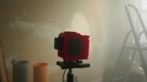 Green Beam of Red Laser Roulette is Displayed on Brown Wall