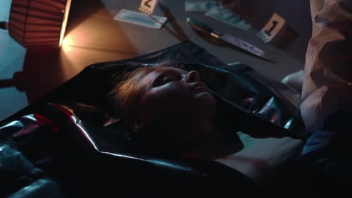A Murdered Woman in a Dark Apartment Illuminated By Blue Red Light From Police Sirens Close Up The