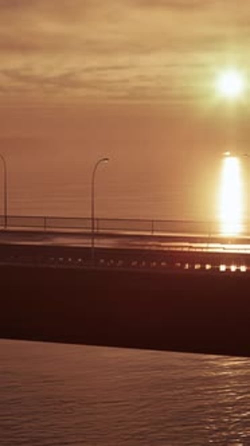 Sunset Over Ocean With Bridge in Foreground