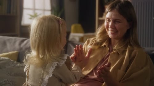 Little Girl Playing Clapping Games with Mother