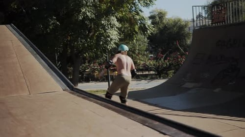 Skateboarder Skating on Ramp in Urban Park