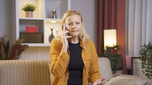 Woman Talking Frustrated on Phone on Couch