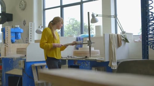Young Woman Shaping Clay on a Pottery Wheel