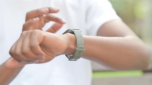 Close up of African Man Using Smartwatch Outdoor