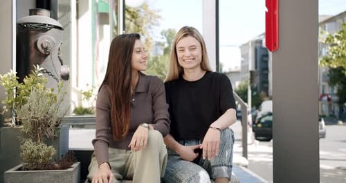 Happy Young Ladies Chatting and Smiling on Street