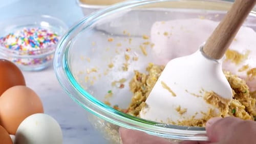 Mixing Cookie Dough with Chocolate Chips and Sprinkles