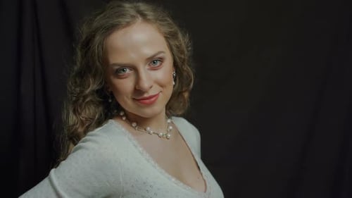 Video Studio Portrait of a Young Girl on a Black Background