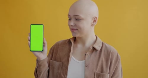 Slow Motion Portrait of Attractive Young Woman Holding Smartphone with Chroma Key Green Screen and