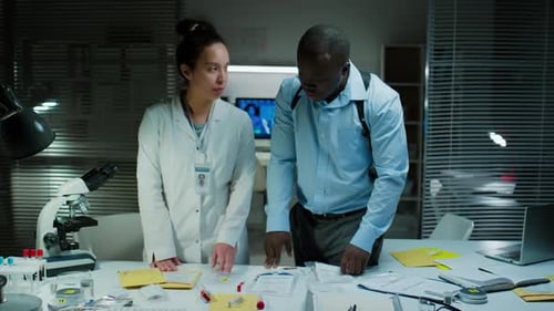 Forensic Scientists Discussing Evidence in Crime Lab