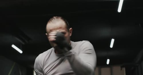 Man Training His Boxing Skills in a Dark Gym Slow Motion