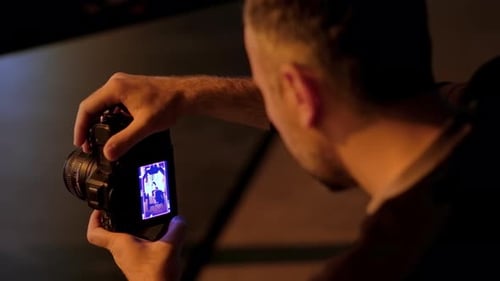 Chisinau, Moldova - March 29, 2024: Man taking vertical video with professional camera on the backst