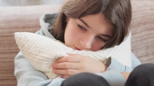 Sad Child Hugs Pillow Inside