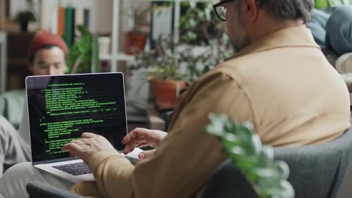Developer Writing Codes on Computer