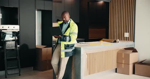 Laptop, renovation and thinking with black man in kitchen for home improvement or upgrade project