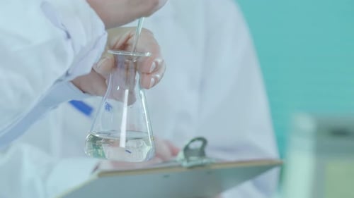 Scientist Conducts Chemical Experiment in Laboratory Close Up