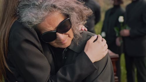 Mourning Lady Being Comforted at Funerals