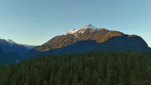 Canadian Mountain Landscape Rocks with Green Trees and Snow on Top