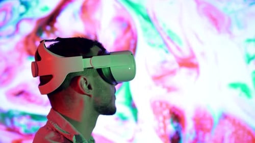 Young Adult Wearing VR Headset with Abstract Background