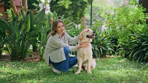 Young Woman Sitting Retriever in Green Park Closeup Relaxed Girl Kneeling Dog