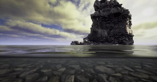 Rocky Coastal Formation Stands Tall Above Water During Cloudy Day