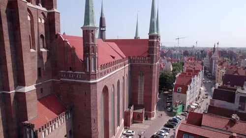 Drone Flight Around the Ancient Cathedral in the Center of the Old European Town with Tile Roofs