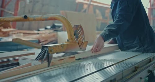 Closeup of an Unrecognizable Male Carpenter in Work Clothes Who Works at a Sawmill