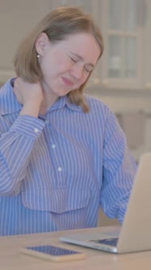 Woman Experiences Neck Pain While Using Laptop