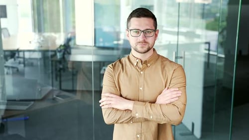 Confident Man with Arms Crossed in Modern Office