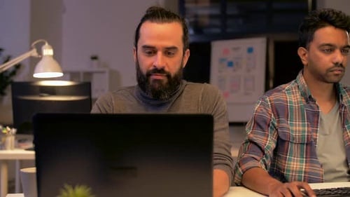 Deadline, Technology and People Concept - Creative Team with Computers Working Late