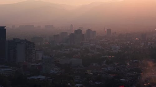 Reddish-toned sunset over Mexico City seen from a drone