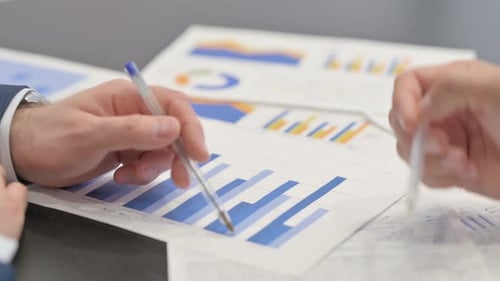 Close Up of Businessmen Hands Doing Paperwork