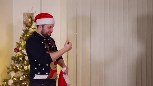 Men celebrate Christmas, putting on Santa hat