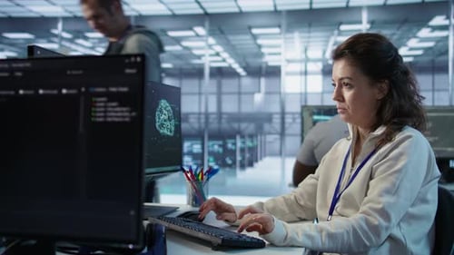 Woman Typing at Computer in Modern Office