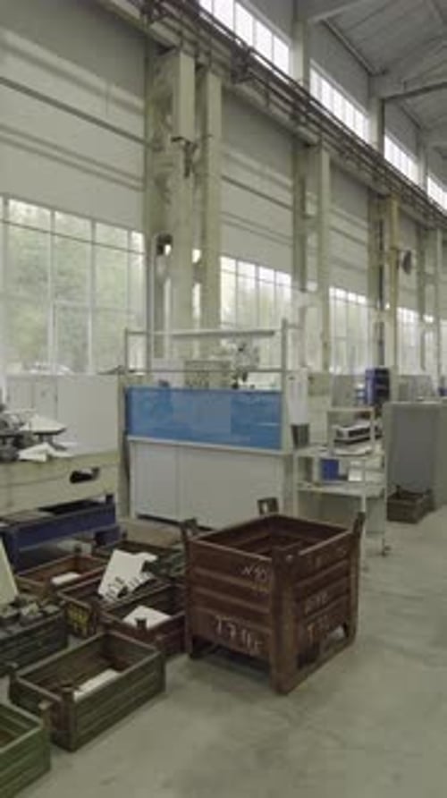 Factory Worker Operating Machinery in Large Industrial Plant Stock Clip