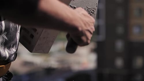 A Builder Lays Bricks at a Construction Site a Closeup of the Worker Hands