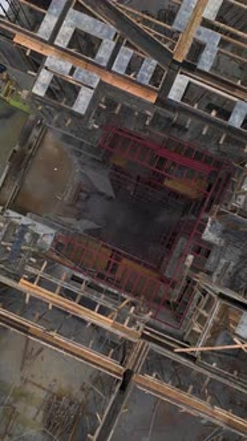 Vertical Video of Team Attaching Large Concrete Plates to Building Side