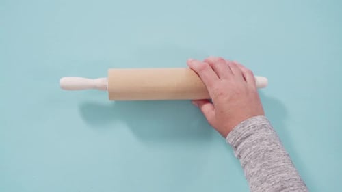 Rolling Pin and Whisk on Blue Surface