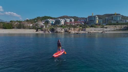Aerial Video Aerial View of Paddleboarding on Calm and Clear Azure Sea Waters