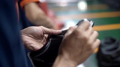 Adult sanding the edge of a shoe