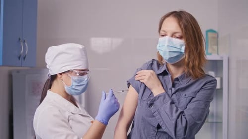 Medical Professional Giving an Injection in a Clinic