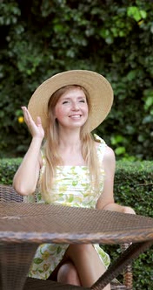 Woman in Straw Hat Sitting at Outdoor Cafe Smiling Summer Happiness