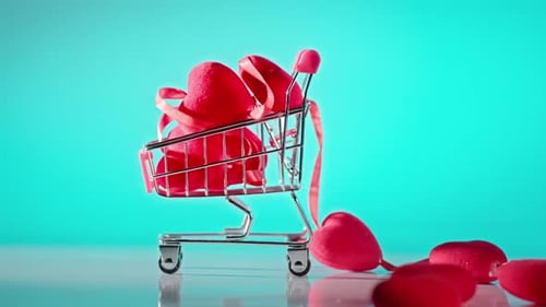 Shopping Cart Filled with Red Hearts and Ribbon
